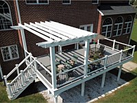 <b>Trex Select Pebble Gray Composite Deck with Trex Composite Railing with black aluminum balusters and a White Vinyl Pergola</b>